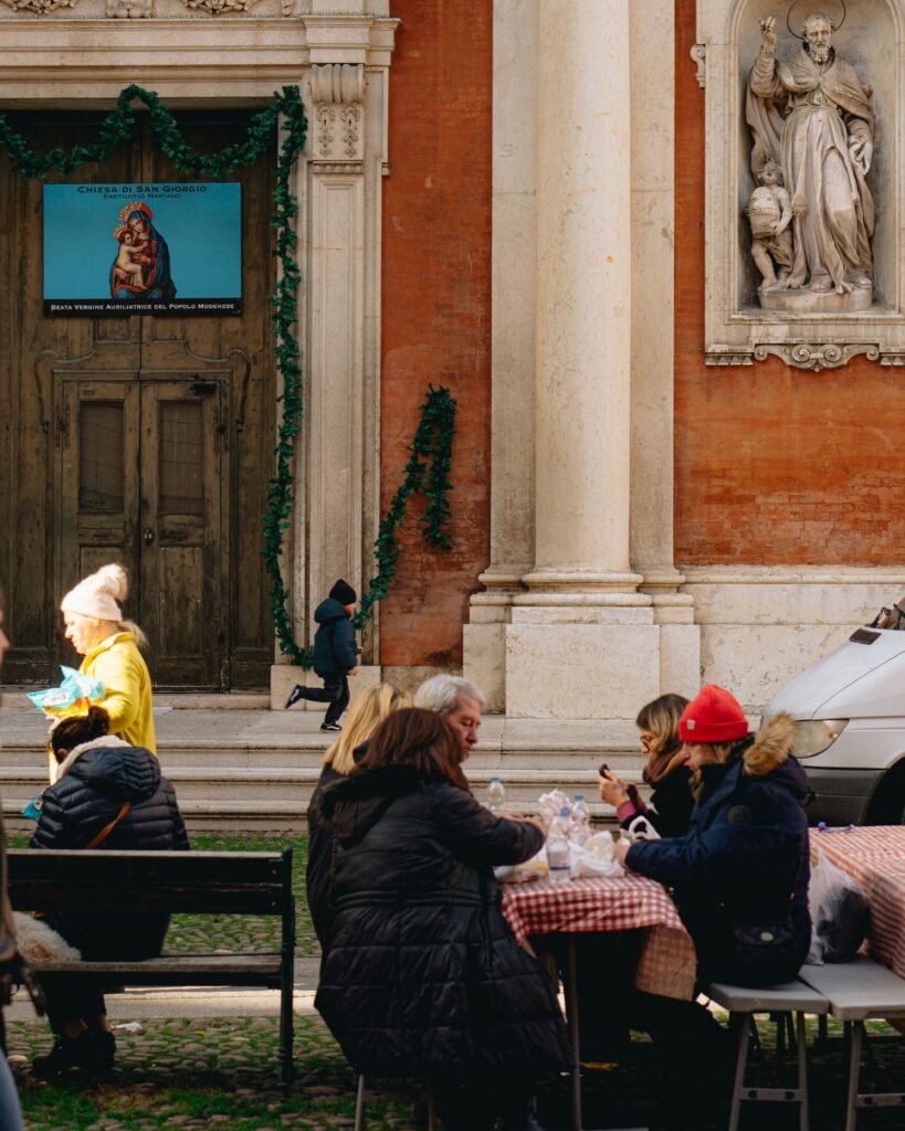 a group of people sitting at a table in front of a building